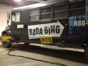 A black bus with the words bada bing on it.