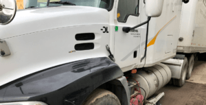 A white truck with black stripe on the side.
