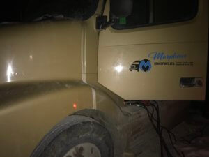 A truck that is parked in the dirt.