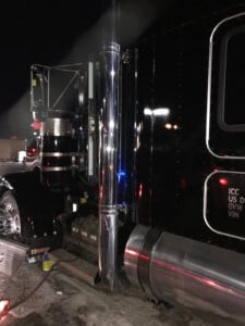 A close up of the side of a truck at night.