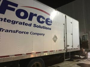 A large white truck with the company logo on it.