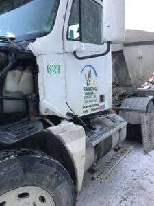 A white truck with the number 6 2 7 on it's side.