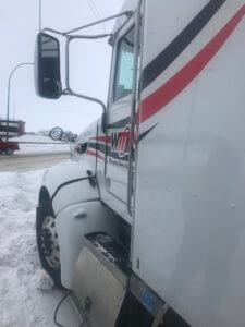 A close up of the side of a semi truck