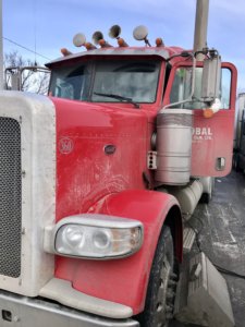 A red truck parked on the side of a road.