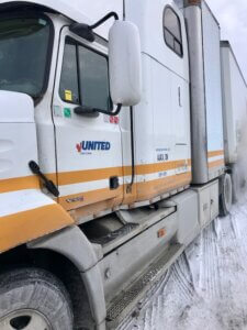 A united truck is parked in the snow.