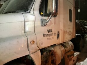 A truck that has been damaged by the side of it.