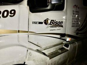 A white truck with the words " bison transport " on it.