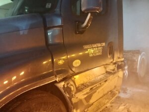 A truck that has been damaged by the side of it.