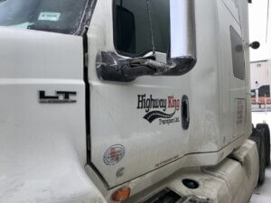 A white truck with its door open and the side of it.